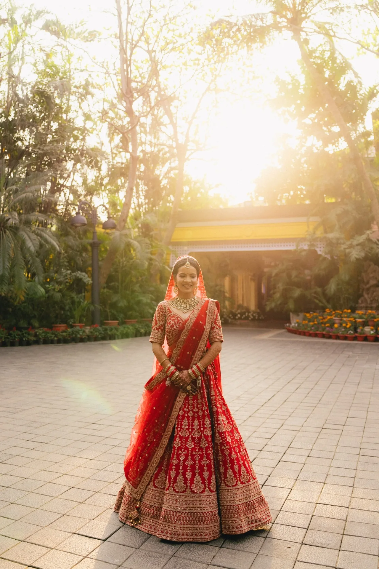 Cuttack bridal makeup artist Romma — bride in red lehenga at golden hour